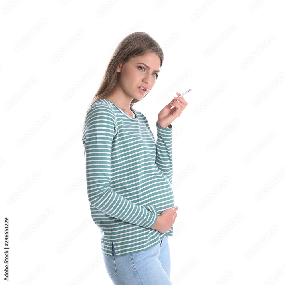 Young pregnant woman smoking cigarette on white background. Harm to unborn baby Young pregnant woman smoking cigarette on white background. Harm to unborn baby
