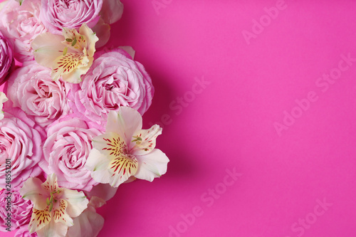 Fresh flowers on color background, top view with space for text