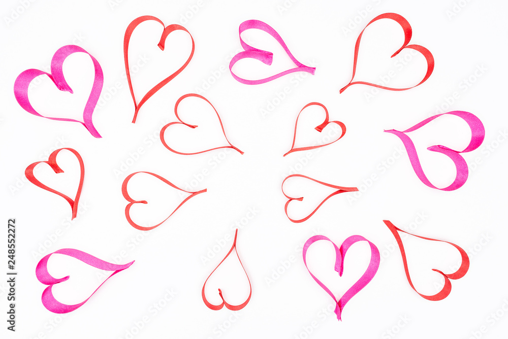 Hearts made from pink and red, satin ribbon on white background with clipping path, view from the top. Valentines Day concept. Hearts made from pink and red, satin ribbon on white background with clipping path, view from the top. Valentines Day concept.