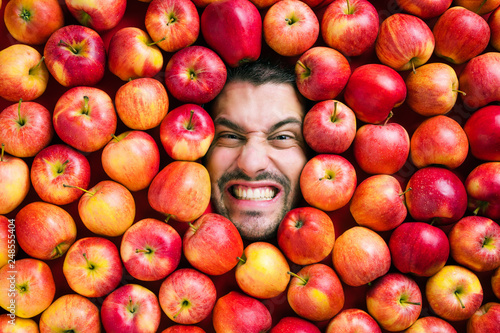 Mann mit Äpfeln , Konzept für Lebensmittelindustrie. Gesicht von lachenden mann  in Apfel Fläche.