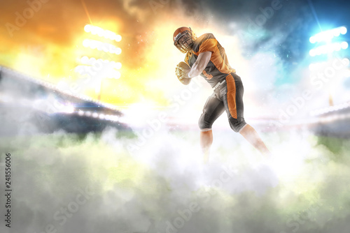 American football player at the stadium in black and orange outfit. © bondarchik