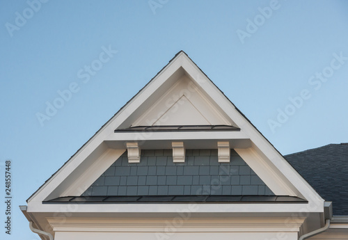 Obraz na plátne Plastic or wood roof decoration gable, corbel on a new construction luxury Ameri