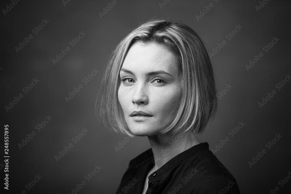 Dramatic black and white portrait of a beautiful woman on a dark background Dramatic black and white portrait of a beautiful woman on a dark background