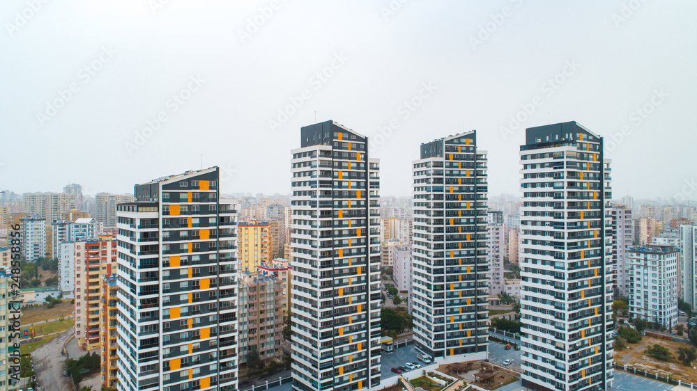 Obraz premium New multi-storey residential building apartment houses aerial view with swimming pool, basketball court and children playground. Mortgage background concept image.