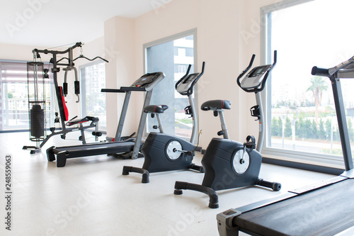 Gym interior and exercise equipments. Apartment gym studio saloon interior