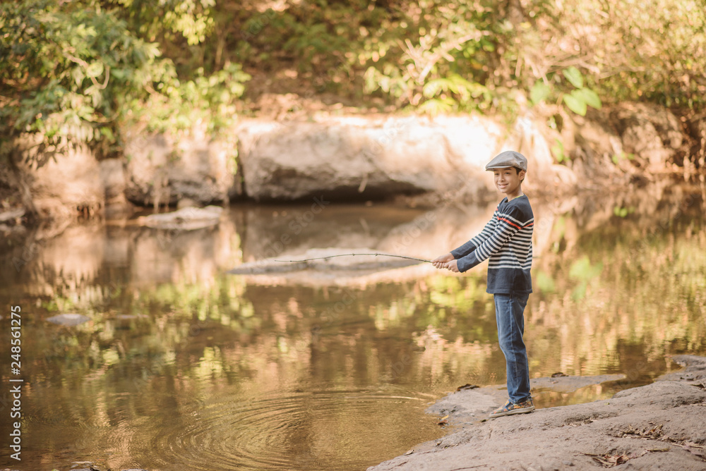 Little Asian boy fishing at the river vintage  retro
