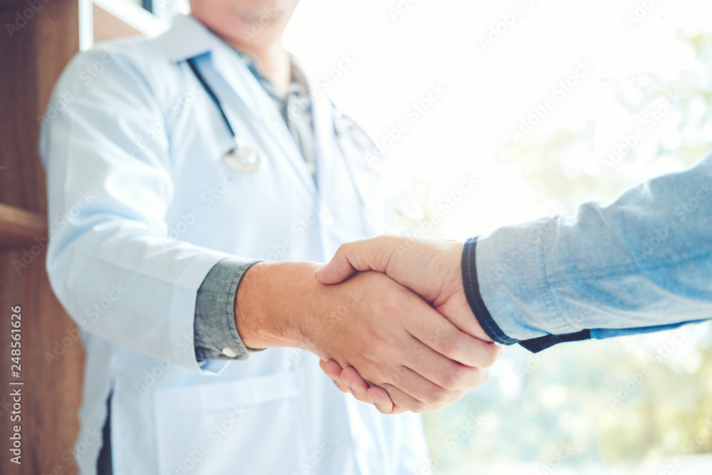 Confident Doctor shaking hands with patients talk in the hospital Confident Doctor shaking hands with patients talk in the hospital