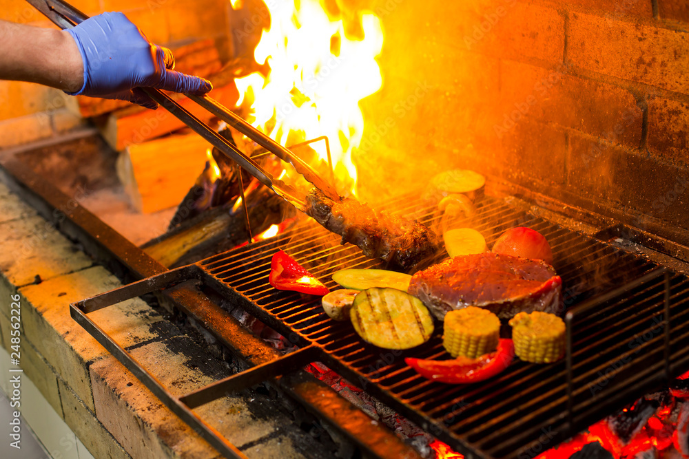 grilled meat and vegetables on an open fire - obrazy, fototapety, plakaty 