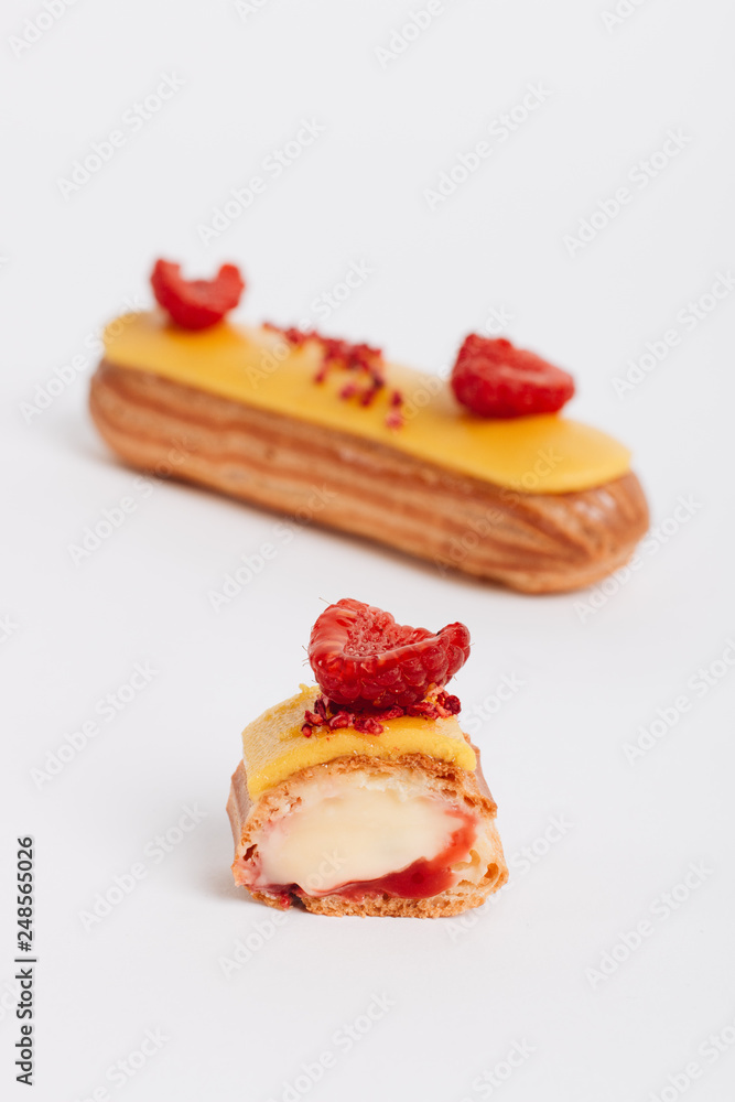 Delicious eclairs with yellow glaze, sweet dessert