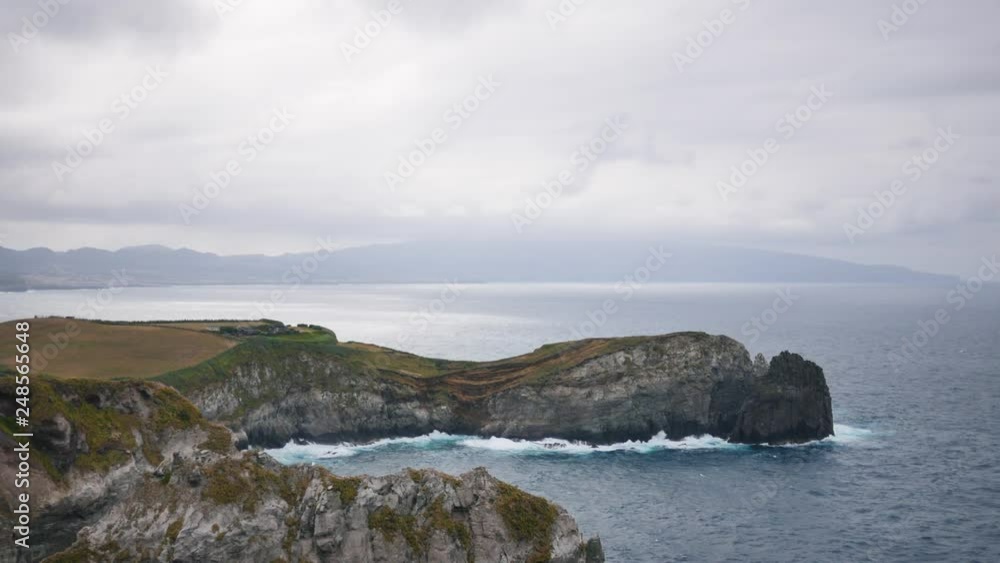 ocean waves on the rocky shore in cloudy weather overlooking the mountain ocean waves on the rocky shore in cloudy weather overlooking the mountain
