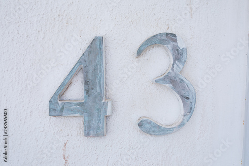 Forty-Three Door Numbers on white wall photo