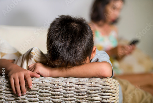 Tela young sad and bored Asian child at home couch feeling frustrated and unattended