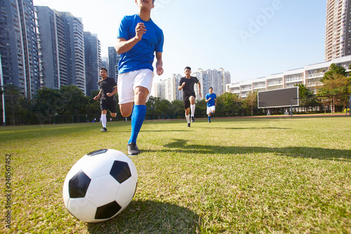 asian soccer football players chasing the ball © imtmphoto