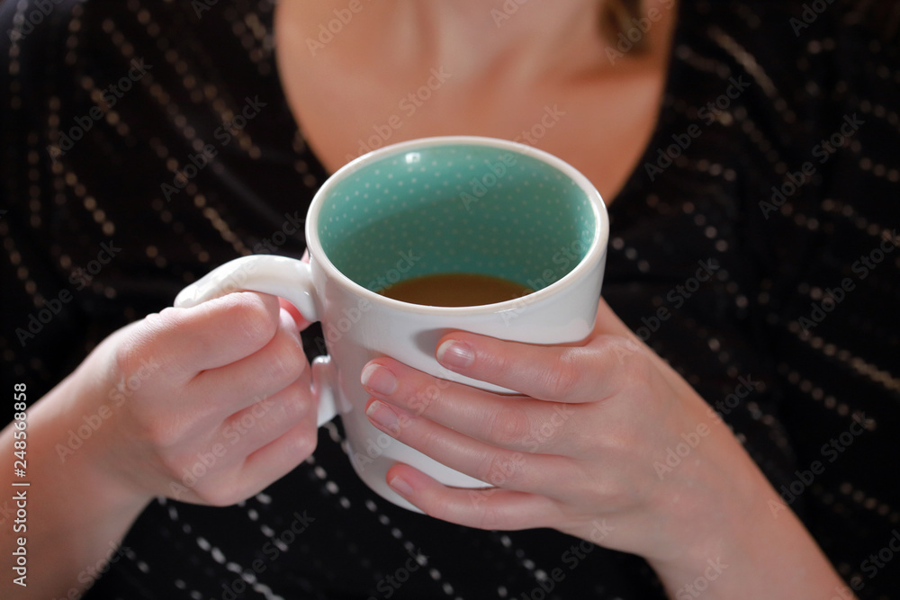 Hands holding mug of hot coffee in the morning Hands holding mug of hot coffee in the morning