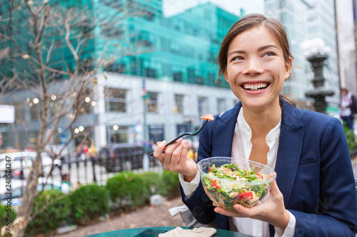 Lunch salad take out bowl healthy eating Asian business woman ready to eat in City Park living lifestyle . Happy smiling multiracial chinese young businesswoman, New York City, USA
