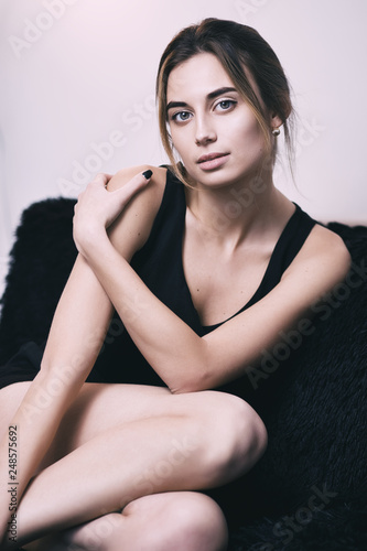 Portrait of young gorgeous woman on sofa, shallow depth of field