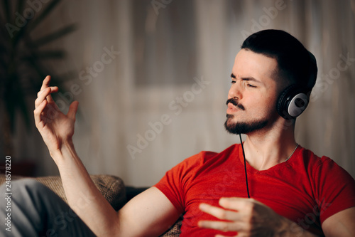Bilde på lerret Funny Man Listening to Music Doing Air Guitar Gesture