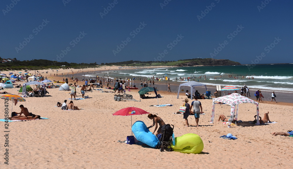 Sydney, Australia - Feb 3, 2019. People relaxing at the beach on a hot sunday in summer time. Dee Why beach, Sydney, NSW, Australia. Sydney, Australia - Feb 3, 2019. People relaxing at the beach on a hot sunday in summer time. Dee Why beach, Sydney, NSW, Australia.