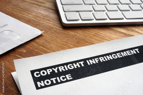 Slika na platnu Letter with copyright infringement notice on a desk.