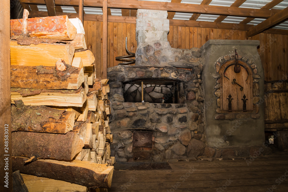 Dudutki, Belarus - September 13, 2018: Traditional Russian stove in a wooden log hut