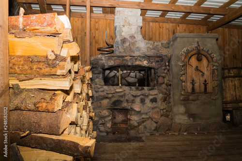 Dudutki, Belarus - September 13, 2018: Traditional Russian stove in a wooden log hut