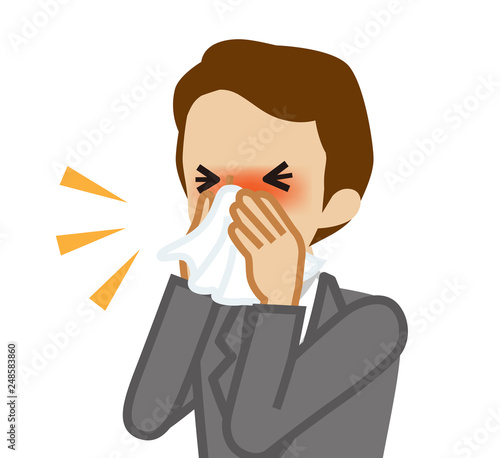Businessman blowing nose with a tissue