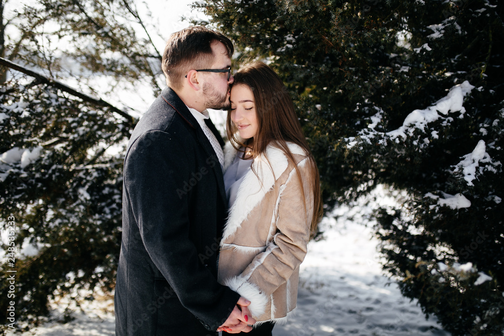 Young Beautiful Couple Taking Fun and Smiling Outdoors in Snowy Winter Young Beautiful Couple Taking Fun and Smiling Outdoors in Snowy Winter