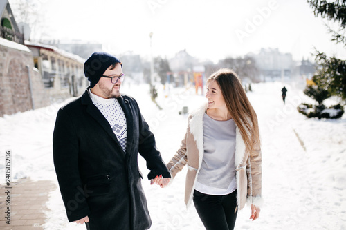 Young Beautiful Couple Taking Fun and Smiling Outdoors in Snowy Winter