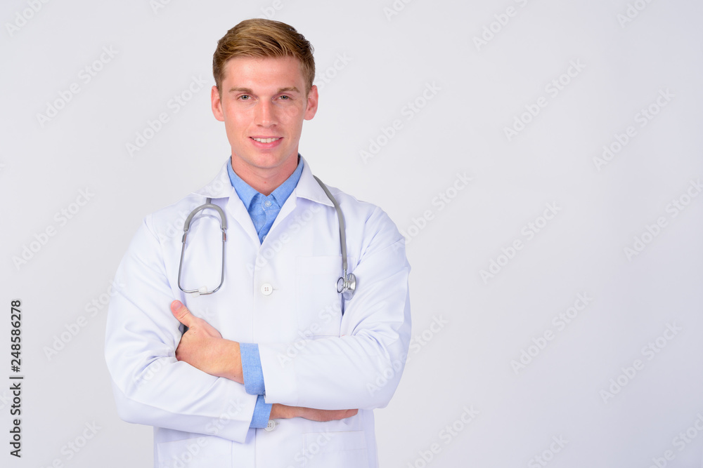 Happy young handsome blonde man doctor with arms crossed Happy young handsome blonde man doctor with arms crossed