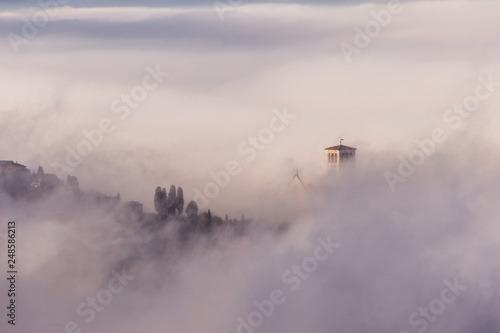 A view of St.Francis church in Assisi (Umbria, Italy) barely visible in the middle of fog