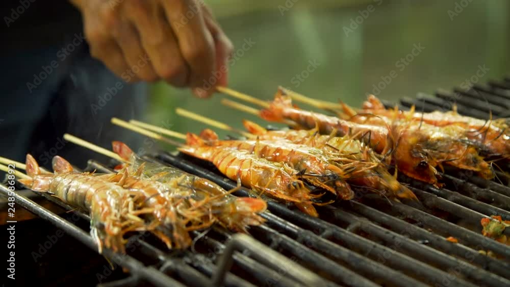 Grilling shrimps over an open fire Grilling shrimps over an open fire