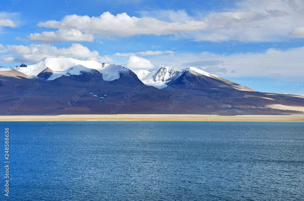 China, Tibet. Clouds above lake Chovo Co (4765 m), located at the foot of the snowy mountains of Koding Kangri (6666 m)