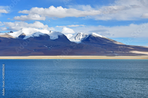 China, Tibet. Clouds above lake Chovo Co (4765 m), located at the foot of the snowy mountains of Koding Kangri (6666 m)