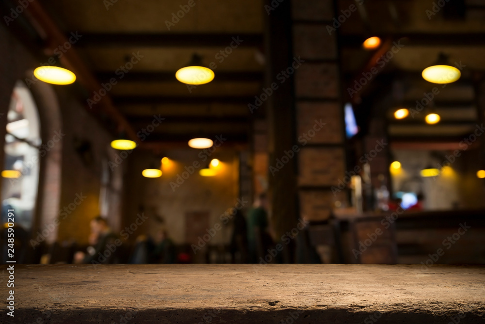 image of wooden table in front of abstract blurred background of resturant lights image of wooden table in front of abstract blurred background of resturant lights
