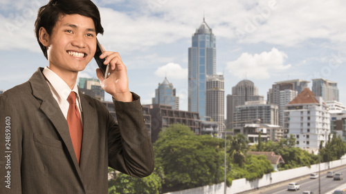 Business man using mobile smart phone in modern city