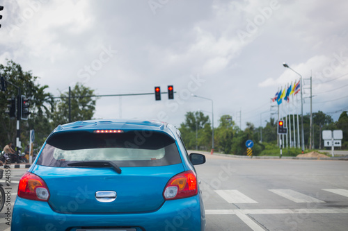 Photography car driving stopped on crossroad with red traffic light