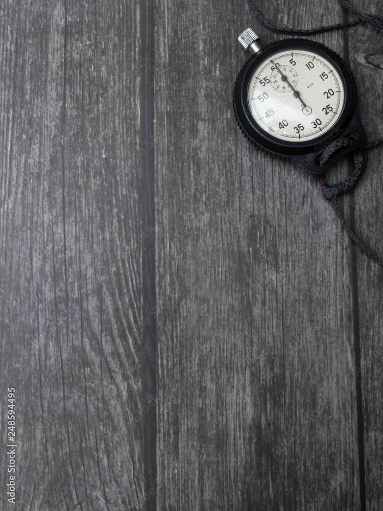 antique mechanical stopwatch, a timer on wooden background antique mechanical stopwatch, a timer on wooden background