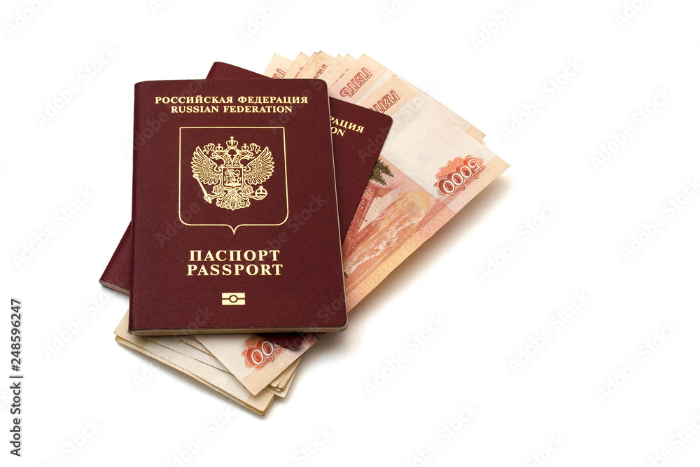 Isolated Russian passports and a pack of five thousandth ruble banknotes on white background Isolated Russian passports and a pack of five thousandth ruble banknotes on white background
