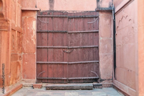 old wooden door in brick wall