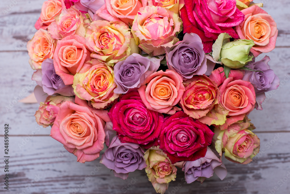 Beautiful bouquet of roses in a gift box. Bouquet of pink roses. Pink roses close-up. on wooden background, with space for text. Beautiful bouquet of roses in a gift box. Bouquet of pink roses. Pink roses close-up. on wooden background, with space for text.
