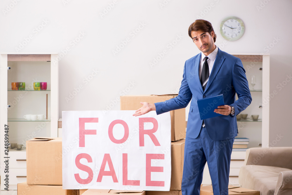 Young handsome realtor selling flat Young handsome realtor selling flat