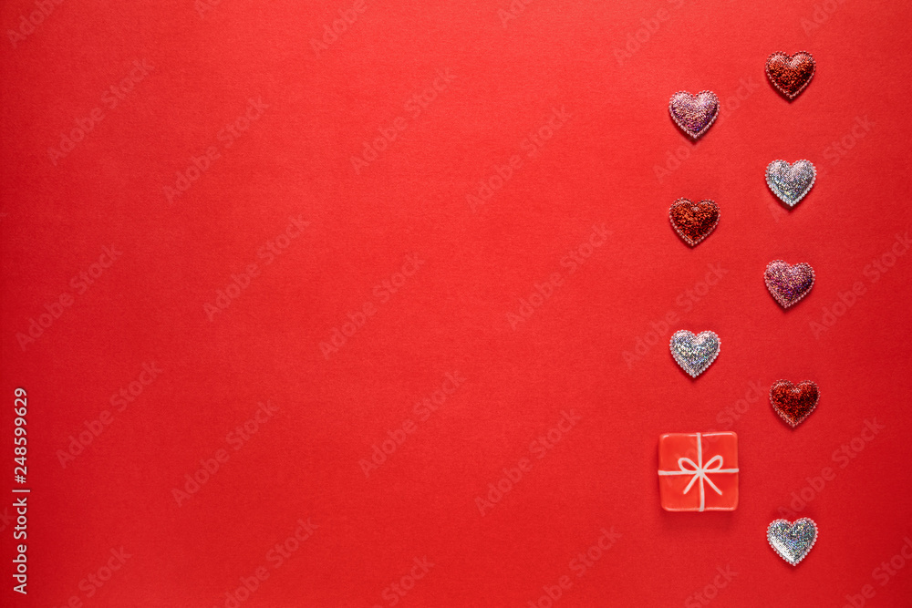 Hearts and toy present on red background.