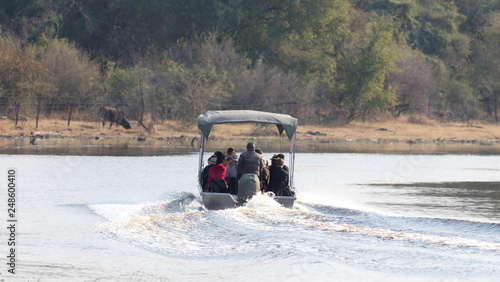 Tourists on a motorboat, on their way to spot hippo's photo