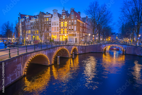 Fényképezés Canals of Amsterdam with dutch buildings at night in Amsterdam city, Netherlands