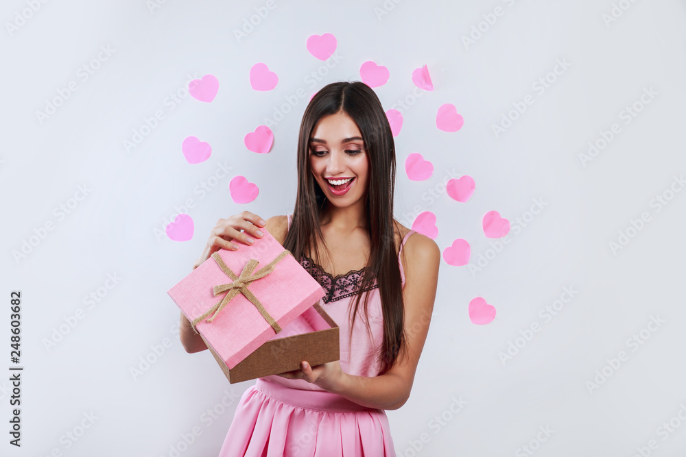Beautiful brunette woman open pink gift box, Valentines day love concept Beautiful brunette woman open pink gift box, Valentines day love concept