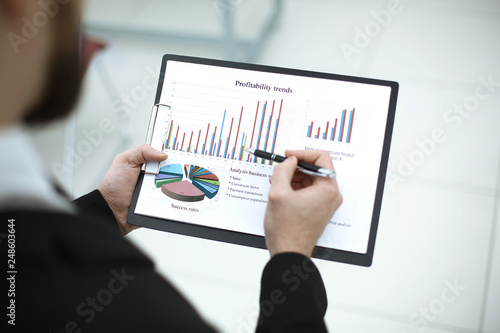 rear view.the businessman checks the financial report.photo with copy space