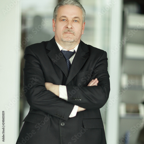 strict businessman on background of office.photo with copy space photo