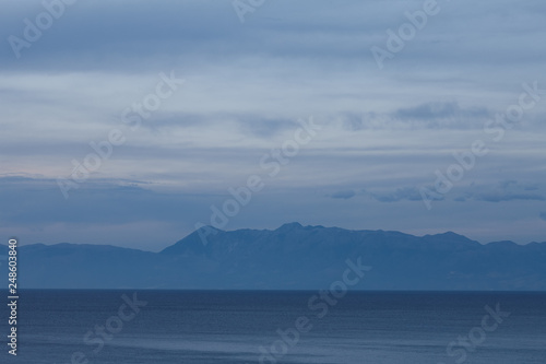 Evening view of Albanian mountains from Greek side. Minimalistic landscape in blue tones.