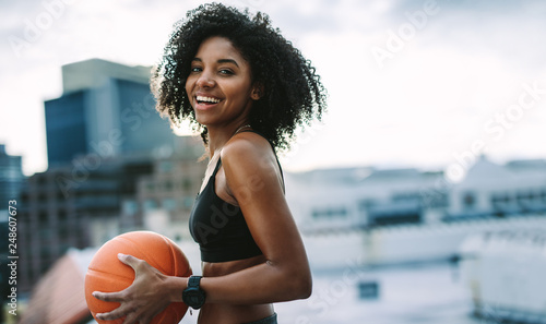 Portrait of a fitness woman holding a basketball © Jacob Lund
