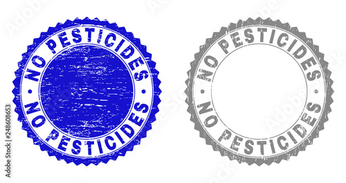 Grunge NO PESTICIDES watermarks isolated on a white background. Rosette seals with grunge texture in blue and grey colors. Vector rubber stamp imitation of NO PESTICIDES title inside round rosette.